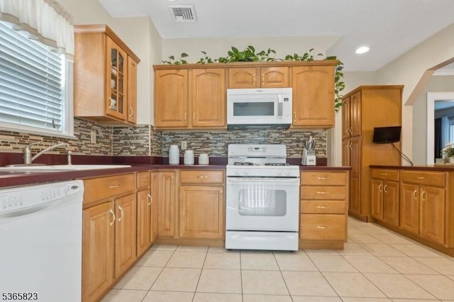 905 Dewitt St, Linden City, NJ 07036 - kitchen with white appliances, tasteful backsplash, glass insert cabinets, light tile patterned floors, and dark countertops