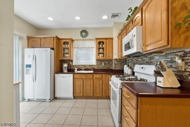 905 Dewitt St, Linden City, NJ 07036 - kitchen featuring white appliances, dark countertops, brown cabinets, and decorative backsplash