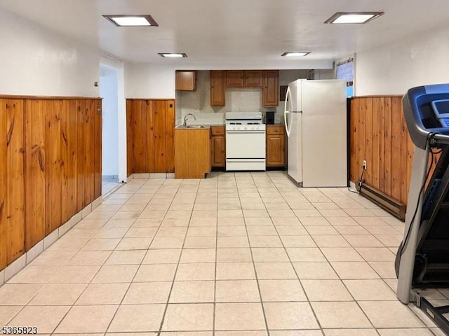 905 Dewitt St, Linden City, NJ 07036 - kitchen featuring white appliances, a wainscoted wall, wooden walls, light countertops, and brown cabinetry