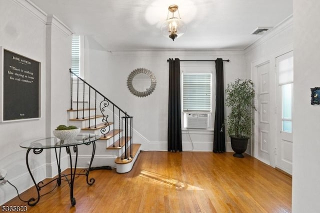 905 Dewitt St, Linden City, NJ 07036 - foyer entrance with stairway, cooling unit, wood finished floors, healthy amount of natural light, and ornamental molding