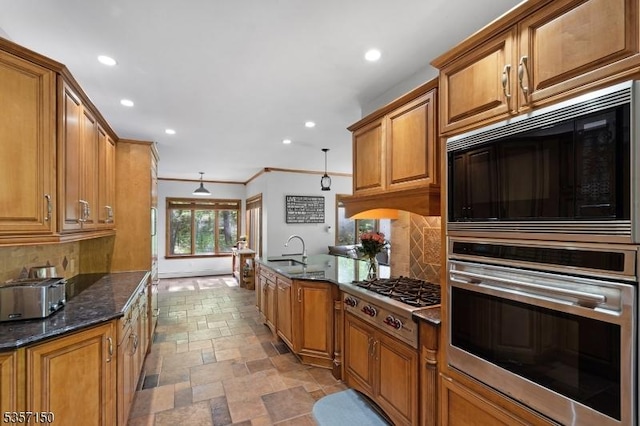 134 Milton Rd, Sparta Twp, NJ 07871 - kitchen featuring appliances with stainless steel finishes, stone tile floors, brown cabinets, recessed lighting, and crown molding