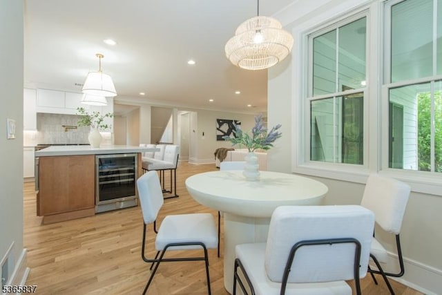 157 Meyersville Rd, Chatham Twp, NJ 07928 - dining space with wine cooler, light wood-style floors, recessed lighting, and ornamental molding