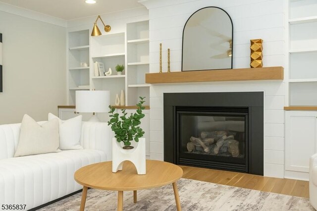 157 Meyersville Rd, Chatham Twp, NJ 07928 - living room featuring wood finished floors, a glass covered fireplace, ornamental molding, and recessed lighting