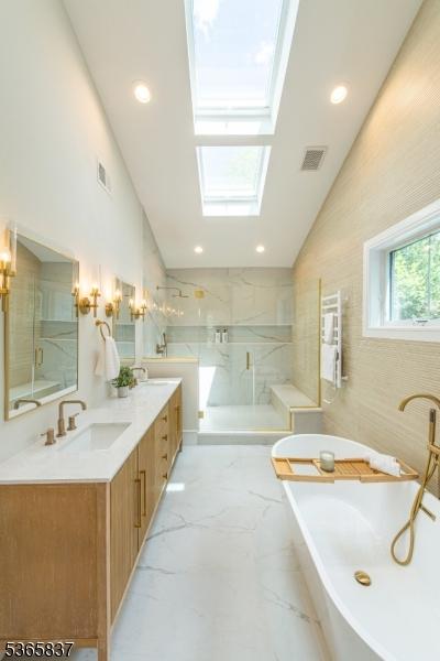 157 Meyersville Rd, Chatham Twp, NJ 07928 - full bath featuring a skylight, a marble finish shower, a freestanding tub, double vanity, and marble finish flooring