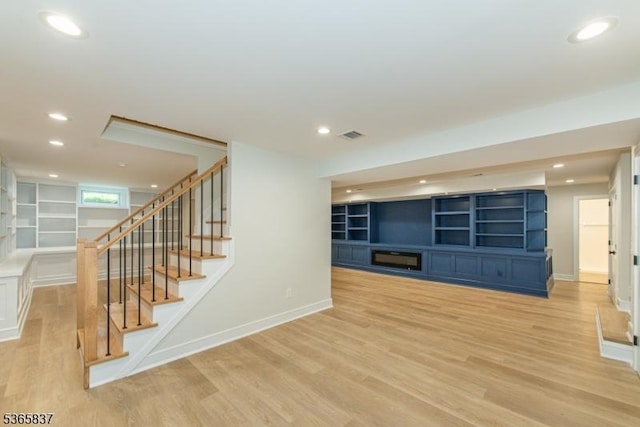 157 Meyersville Rd, Chatham Twp, NJ 07928 - unfurnished living room featuring light wood-style floors, built in features, stairs, and recessed lighting