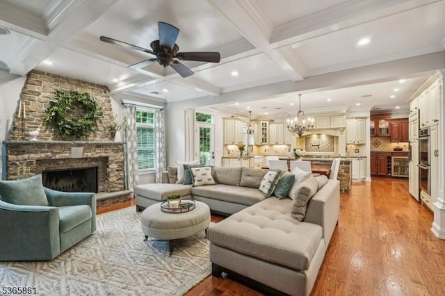 27 Wesley Ct, New Providence Boro, NJ 07974 - living area with ornamental molding, coffered ceiling, light wood-style flooring, beamed ceiling, and a stone fireplace