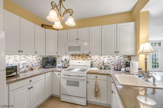 7108 Ravenscroft Rd Unit 7108, Clifton City, NJ 07013 - kitchen featuring white appliances, white cabinetry, and decorative backsplash