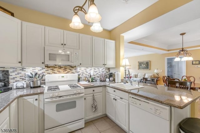 7108 Ravenscroft Rd Unit 7108, Clifton City, NJ 07013 - kitchen featuring white appliances, a peninsula, tasteful backsplash, white cabinetry, and pendant lighting