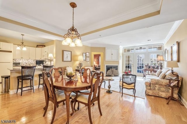 7108 Ravenscroft Rd Unit 7108, Clifton City, NJ 07013 - dining space with crown molding, a raised ceiling, light wood-type flooring, and a fireplace