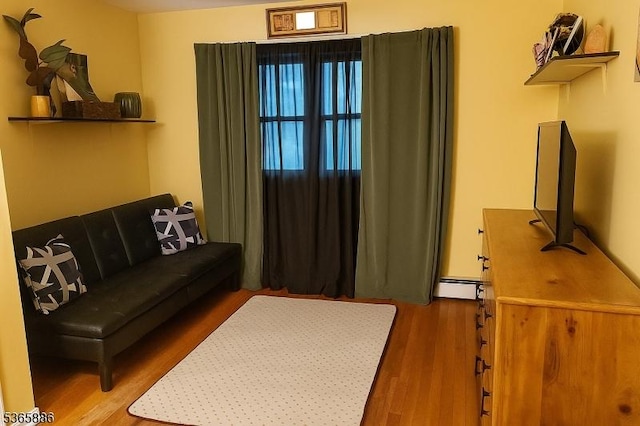 452 W 4th Ave, Roselle Boro, NJ 07203 - living area featuring wood finished floors and a baseboard radiator