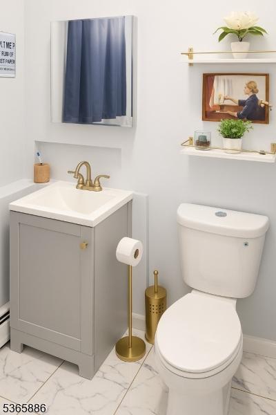 452 W 4th Ave, Roselle Boro, NJ 07203 - half bathroom with marble look tiles and vanity
