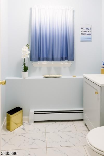 452 W 4th Ave, Roselle Boro, NJ 07203 - bathroom with marble finish floors, baseboard heating, and vanity