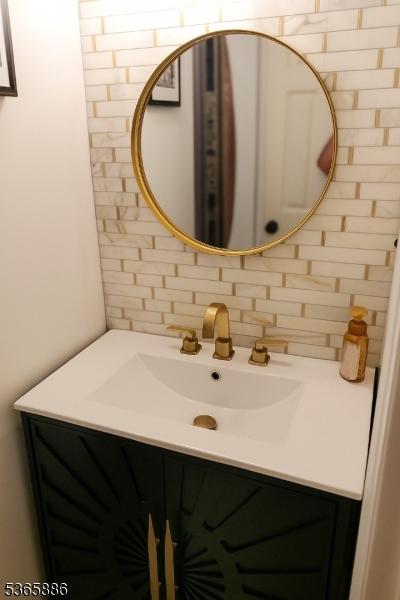 452 W 4th Ave, Roselle Boro, NJ 07203 - bathroom with tasteful backsplash and vanity