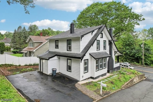 62 Rt46, Mine Hill Twp, NJ 07803 - back of house featuring a shingled roof, a chimney, asphalt driveway, and a garden