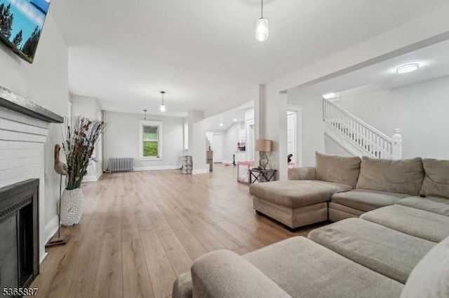62 Rt46, Mine Hill Twp, NJ 07803 - living area featuring radiator, light wood-style floors, stairs, and a fireplace