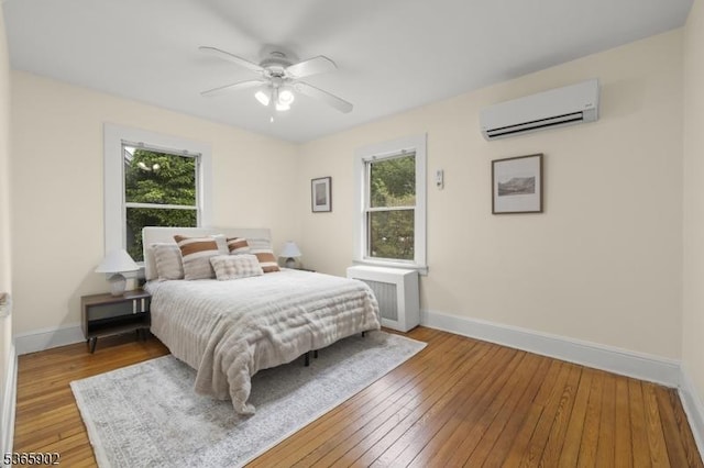 72 Meadowbrook Rd, Millburn Twp, NJ 07078 - bedroom featuring a wall mounted air conditioner, multiple windows, wood-type flooring, and ceiling fan