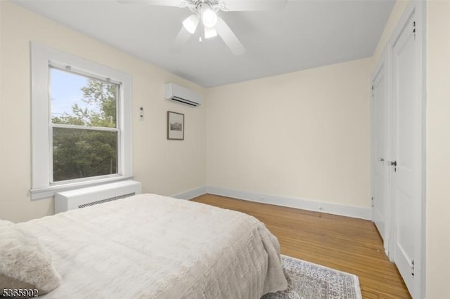 72 Meadowbrook Rd, Millburn Twp, NJ 07078 - bedroom with a wall unit AC, light wood-type flooring, and a ceiling fan
