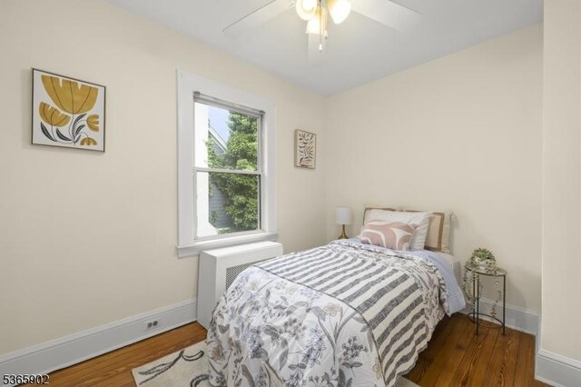 72 Meadowbrook Rd, Millburn Twp, NJ 07078 - bedroom with wood finished floors, radiator, and ceiling fan