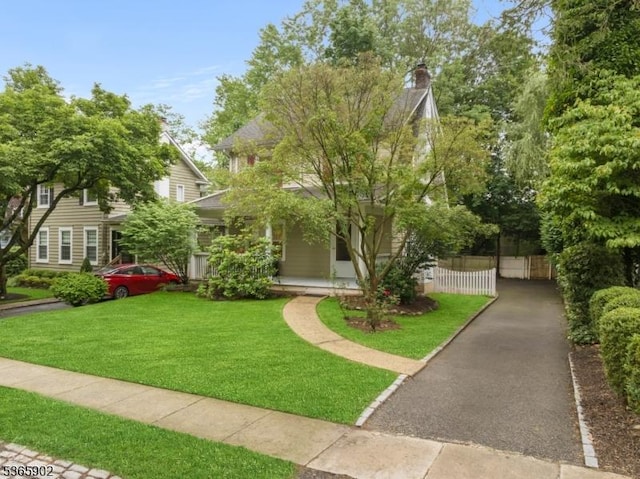 72 Meadowbrook Rd, Millburn Twp, NJ 07078 - view of property hidden behind natural elements with a chimney and a porch