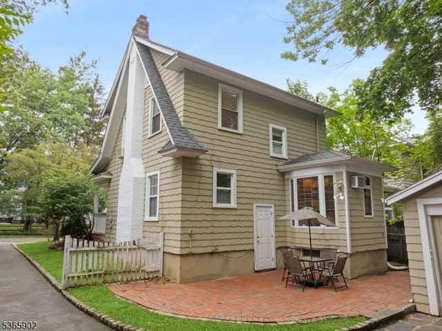 72 Meadowbrook Rd, Millburn Twp, NJ 07078 - back of house with a patio area, a chimney, and roof with shingles