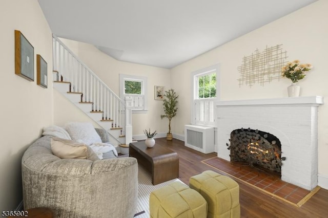 72 Meadowbrook Rd, Millburn Twp, NJ 07078 - living room featuring radiator heating unit, wood finished floors, a fireplace, and stairway