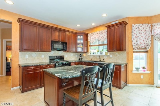 48 Saunders Ln, Mount Olive Twp, NJ 07840 - kitchen featuring black appliances, tasteful backsplash, a breakfast bar, healthy amount of natural light, and recessed lighting