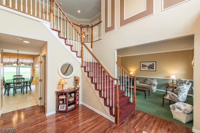 48 Saunders Ln, Mount Olive Twp, NJ 07840 - stairway with a high ceiling, wood finished floors, a chandelier, ornamental molding, and recessed lighting