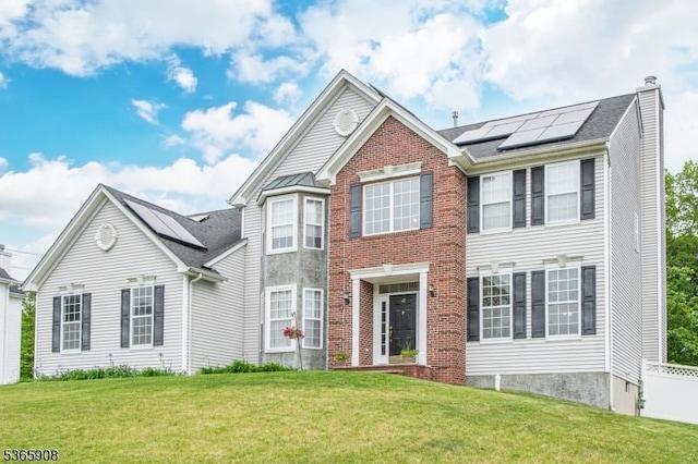 48 Saunders Ln, Mount Olive Twp, NJ 07840 - view of front of property with solar panels, a front yard, and brick siding