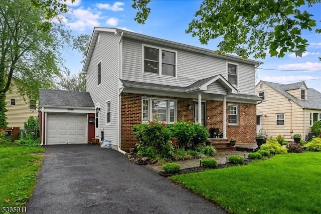 1592 Front St, Scotch Plains Twp, NJ 07076 - view of front facade featuring a front yard, brick siding, and asphalt driveway