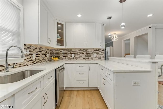 1592 Front St, Scotch Plains Twp, NJ 07076 - kitchen featuring stainless steel appliances, a peninsula, white cabinets, decorative backsplash, and recessed lighting