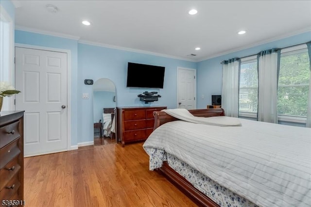 1592 Front St, Scotch Plains Twp, NJ 07076 - bedroom with light wood-style floors, crown molding, recessed lighting, and arched walkways