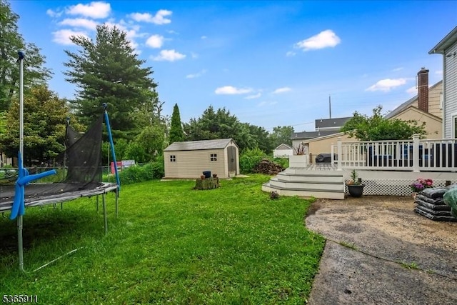 1592 Front St, Scotch Plains Twp, NJ 07076 - view of grassy yard with a trampoline, a storage unit, and a deck