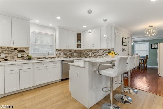 1592 Front St, Scotch Plains Twp, NJ 07076 - kitchen featuring dishwasher, a breakfast bar area, white cabinets, and recessed lighting