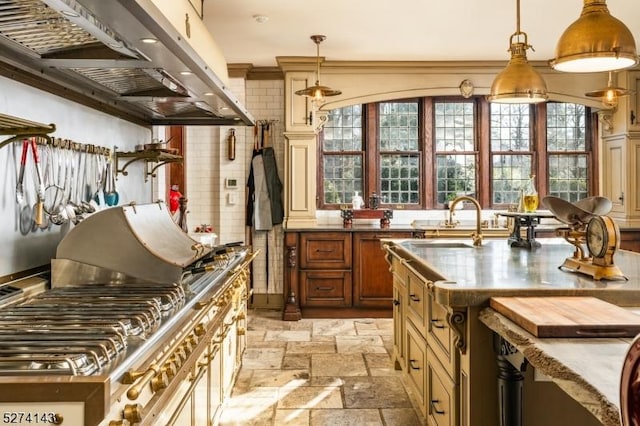 12 Canfield Rd, Morris Twp, NJ 07960 - kitchen featuring range hood, stone tile floors, pendant lighting, and a kitchen island with sink