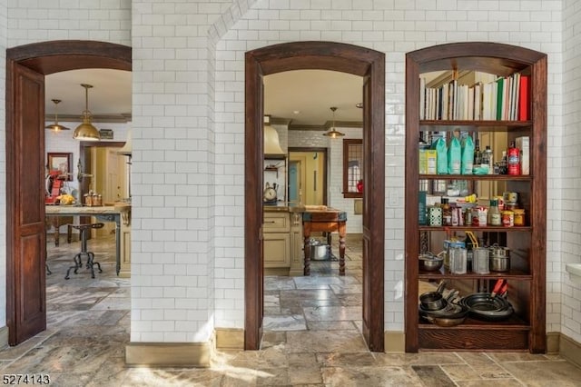 12 Canfield Rd, Morris Twp, NJ 07960 - hallway with stone tile flooring, ornamental molding, and arched walkways