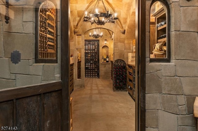 12 Canfield Rd, Morris Twp, NJ 07960 - wine area featuring arched walkways, concrete flooring, and a chandelier