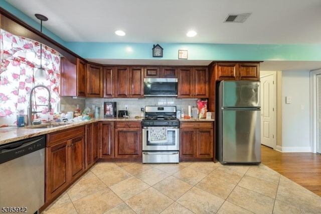 29 E Price St Unit 4, Linden City, NJ 07036 - kitchen featuring appliances with stainless steel finishes, backsplash, recessed lighting, light tile patterned floors, and decorative light fixtures