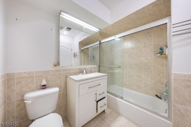 29 E Price St Unit 4, Linden City, NJ 07036 - bathroom featuring tile walls, vanity, bath / shower combo with glass door, tile patterned flooring, and a wainscoted wall