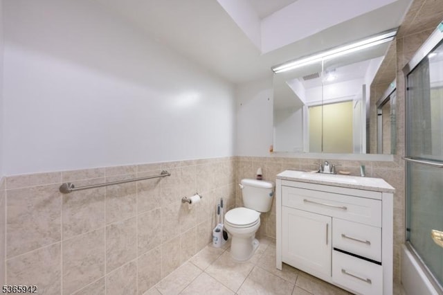29 E Price St Unit 4, Linden City, NJ 07036 - bathroom with vanity, tile walls, tile patterned flooring, a wainscoted wall, and enclosed tub / shower combo
