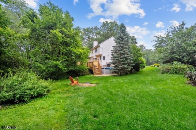 51 Bertran Dr, Bridgewater Twp, NJ 08807 - view of grassy yard featuring a wooden deck
