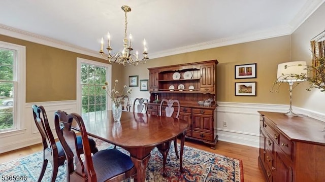 10 Walnut Grove Rd, Hillsborough Twp, NJ 08844 - dining area featuring a chandelier, healthy amount of natural light, light wood-style floors, a wainscoted wall, and ornamental molding