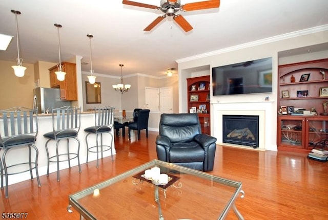 10 Cliff Rd Unit A3, Woodland Park, NJ 07424 - living room featuring wood finished floors, ceiling fan, crown molding, a glass covered fireplace, and a chandelier