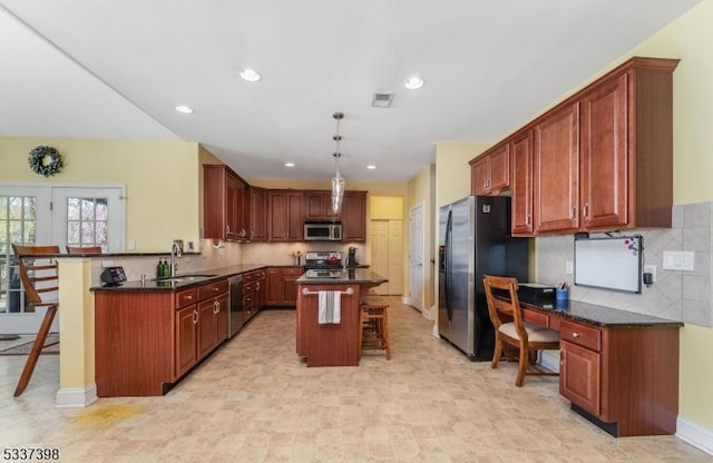 36 Crestview Dr, Clinton Twp, NJ 08809 - kitchen with appliances with stainless steel finishes, a breakfast bar area, backsplash, a kitchen island, and recessed lighting