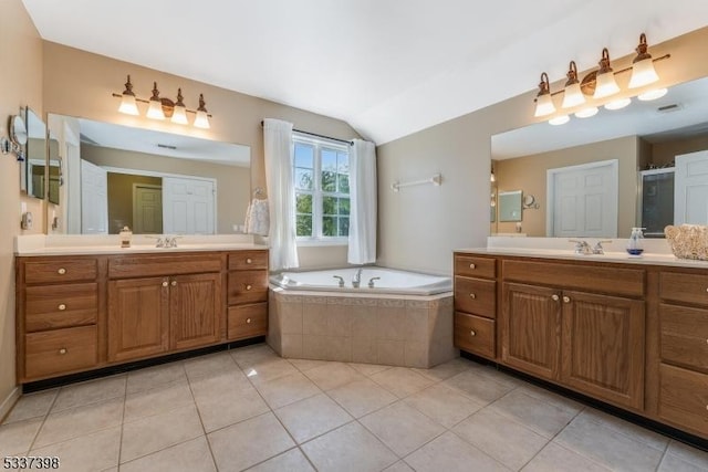36 Crestview Dr, Clinton Twp, NJ 08809 - bathroom with two vanities, tile patterned floors, a bath, and vaulted ceiling