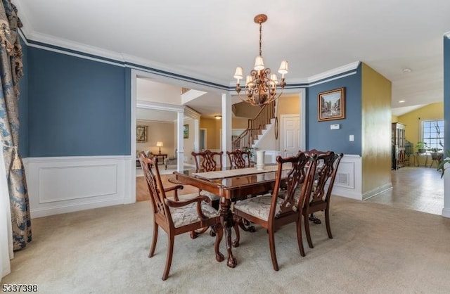36 Crestview Dr, Clinton Twp, NJ 08809 - dining area featuring crown molding, a chandelier, light colored carpet, stairway, and wainscoting