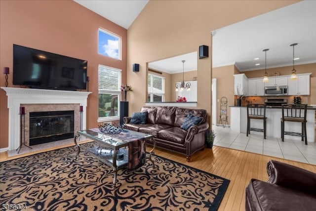 18 Running Brook Cir, Raritan Twp, NJ 08822 - living area with light wood finished floors, high vaulted ceiling, a chandelier, a fireplace, and ornamental molding