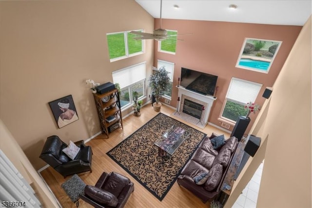 18 Running Brook Cir, Raritan Twp, NJ 08822 - living room featuring high vaulted ceiling, healthy amount of natural light, wood finished floors, a fireplace, and a ceiling fan