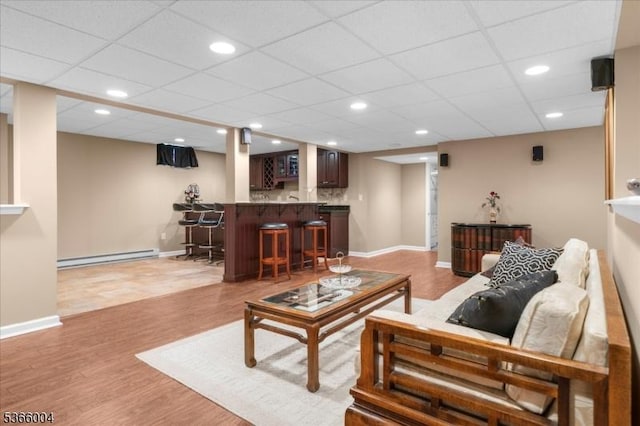 18 Running Brook Cir, Raritan Twp, NJ 08822 - living area featuring a baseboard heating unit, bar, light wood-type flooring, recessed lighting, and a drop ceiling