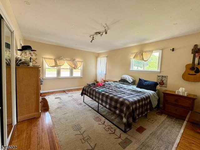 77 Belvidere Ave, Oxford Twp, NJ 07863 - bedroom with wood finished floors, multiple windows, and track lighting