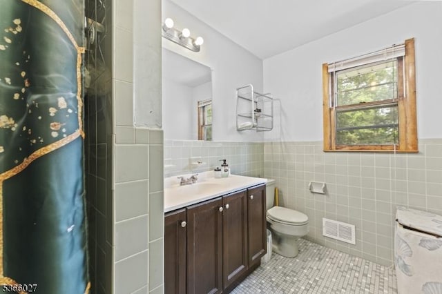 132 N 17th St, Prospect Park Boro, NJ 07508 - bathroom featuring tile walls, vanity, tile patterned flooring, and wainscoting